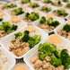 Zesty bang bang chicken with broccoli and rice, spicy sauce on the side.