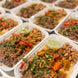 Beautifully prepared Beef Barbacoa Bowls that include various ingredients, such as beans, peppers and cilantro.