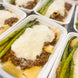 A creamy and meaty beef bechamel on a bed of rigatoni with a side of cooked asparagus.