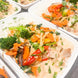 A sweet and spicy coconut chicken red curry with fresh vegetables and a parsley garnish.