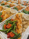 A fresh fish plate featuring grilled haddock, green beans, carrots, and rice with lemon and tartar sauce.